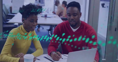 Tech team collaborating around white office table, displaying green data-code Stock Footage 308571515
