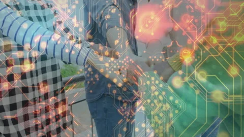 Tech team extending fists on terrace sparking circuit overlay while opening Stock Footage 312656761