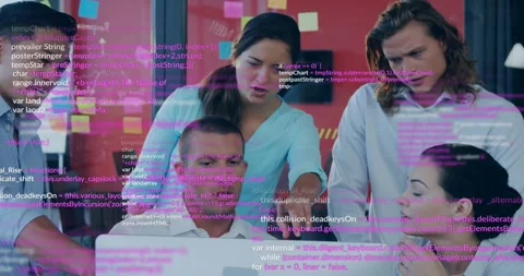 Tech team gathering at desk code overlay appearing above monitor pointing Stock Footage 318544920