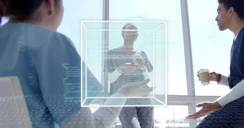 Tech team holding coffee and analyzing wireframe cube materializing with code Stock Footage 314734949