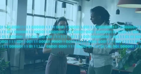 Tech team reviewing data tapping laptop and swiping tablet starting binary code Stock Footage 317600175