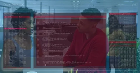 Tech team reviewing script over laptop as Data Terminal overlay fading Stock Footage 317869725