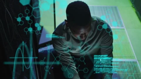 Tech touching console and activating holograms, overlays growing into code Stock Footage 332625455