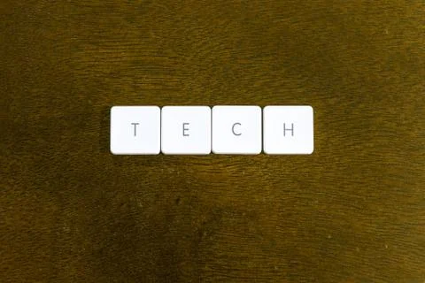 TECH word written on plastic keyboard alphabet with dark background Stock Photos