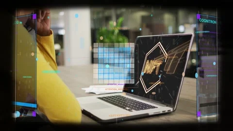 Tech worker leaning on elbow reviewing NFT dashboard, laptop showing emblem Stock Footage 332544599