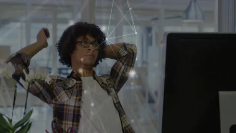 Tech worker pausing typing stretching to focus fixing specs resuming work as Stock Footage 332428345