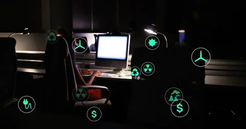 Tech worker powering PC and typing while green energy icons animating Stock Footage 314742348