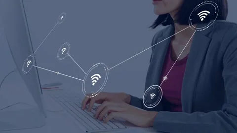 Tech worker typing on keys starting WiFi icons fanning showing network to head Stock Footage 335731905