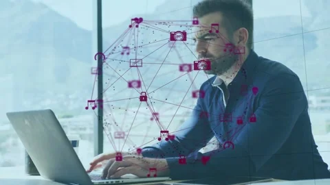 Tech worker typing laptop at window, initiating icon network over screen for Stock Footage 335465725