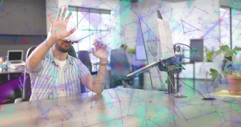 Techie wearing VR headset exploring interface in office, manipulating overlaid Stock Footage 315305984