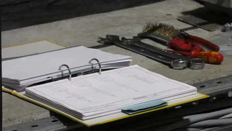 Technical documentation lies on a concrete slab Stock-Footage 101026137