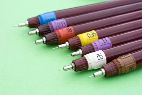 Technical drawing pens on green background Foto stock