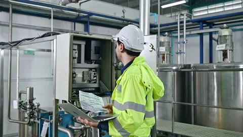 Technical engineer with laptop, paperwork checking condition of transformer p Video stock 185530657