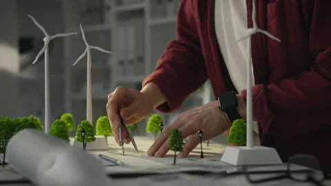 A technical engineer uses models of wind turbines. The designer develops pro Stock Footage 271155810