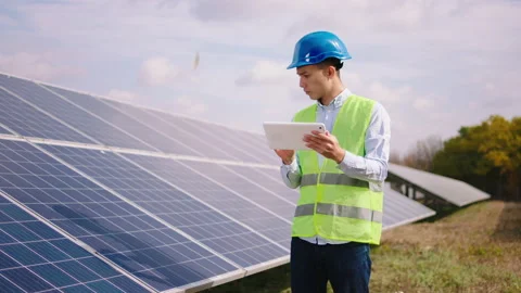 Technical expert at solar power farm using digital tablet to controlling the Stock Footage 163971738