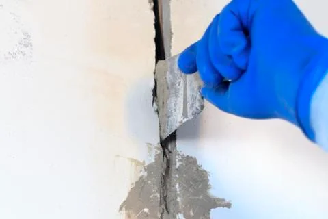 Technical hole in it is an electrical wire. the wall is white. Master with a  Fotos Stock