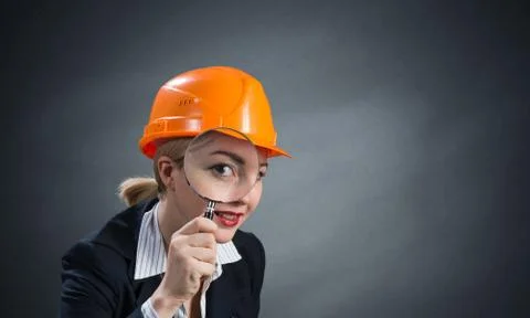 Technical inspector looking through magnifier Stock Photos