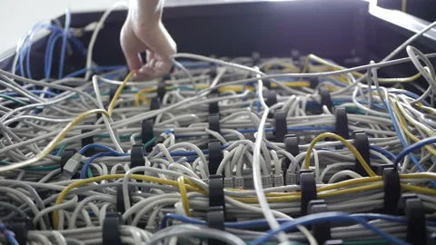 A technical IT specialist digs in the wires in search of a problem Stock Footage 114498433