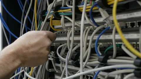 A technical IT specialist digs in the wires in search of a problem Video stock 114500361
