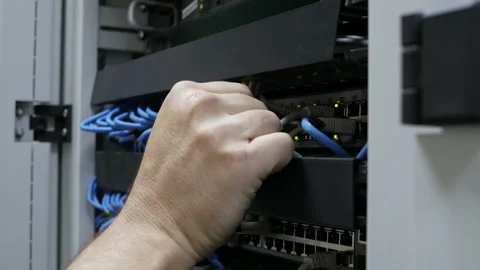 A technical IT specialist digs in the wires in search of a problem. Video stock 114502790