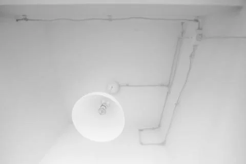 Technical lamp on ceiling all white Foto stock