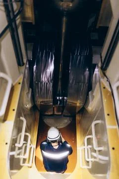 Technical maintenance: Ship mechanic working inside a giant diesel engine. Stock Photos