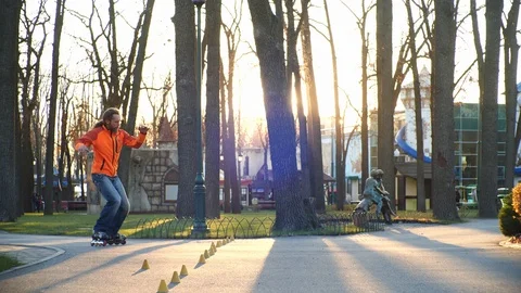 A technical man on roller skates professionally rides backwards and conducts Stock Footage 124807596