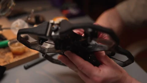 Technical professional assembling fpv drone, checking intricate components and Stock Footage 302564971