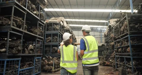 Technical with safety suit helmet walking around car industry checking stock  Vídeo Stock 173386337