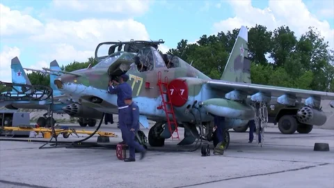 Technical service preparing the fighter jet SU-25 for take-off at a military Stock Footage 73479906