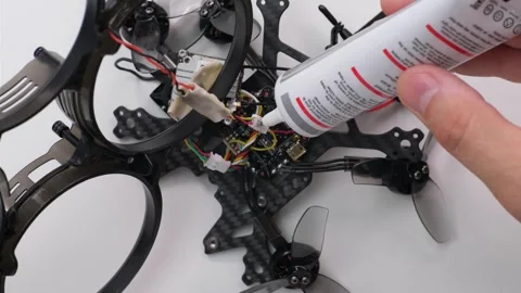 Technical Specialist apply silicone polish to drone fpv Stock Footage 244335057