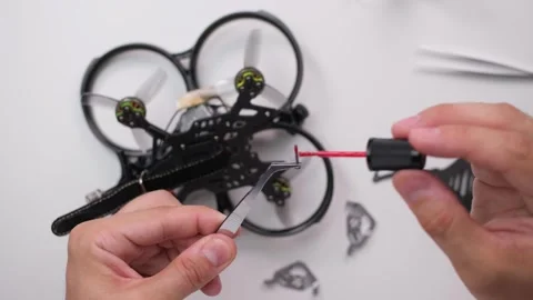 Technical Specialist apply thread lock on bolt of  fpv quadrocopter Stock Footage 244335822