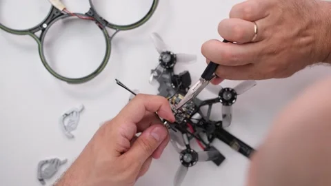 Technical specialist assembly fpv drone screw video transmitter air unit Stock Footage 244336022