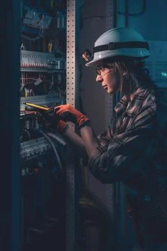 Technical specialist inspecting electrical system with voltage tester. Engi.. Stock Photos