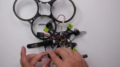 Technical Specialist install motor to drone fpv quadrocopter Stock Footage 244335667