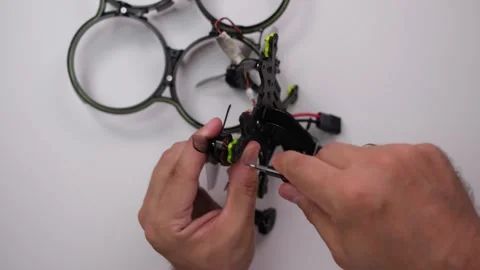Technical Specialist install motor on fpv quadrocopter Stock Footage 244335517