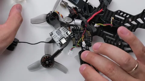 Technical Specialist take apart to apply silicon on microchips drone fpv Stock Footage 244332892