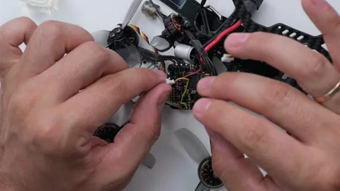 Technical Specialist take apart fpv drone to apply silicone polish Stock Footage 244332931