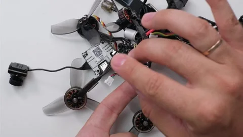 Technical Specialist take apart fpv drone to apply silicone on microchips Stock Footage 244333073