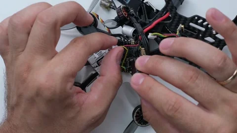 Technical Specialist take apart fpv drone to apply silicone Stock Footage 244333258