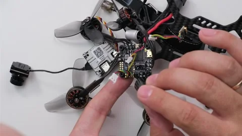 Technical Specialist take apart fpv drone to apply polish on microchips Stock Footage 244333259