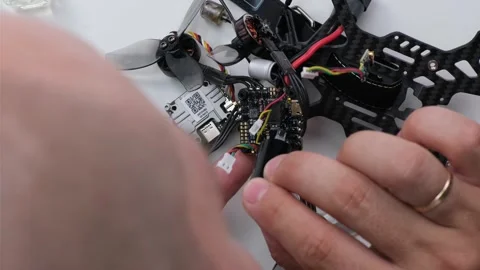 Technical Specialist take apart fpv drone to apply polish silicone on microchips Stock Footage 244333261
