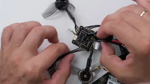 Technical Specialist take apart fpv drone to apply waterproof silicone Stock Footage 244333604