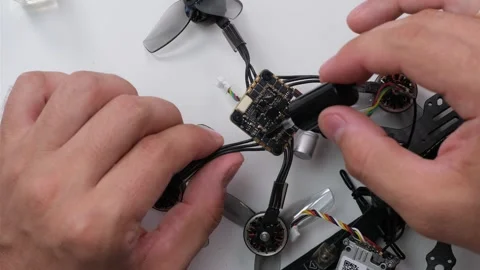 Technical Specialist take apart fpv drone to apply silicone polish Stock Footage 244333677