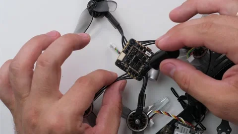Technical Specialist take apart fpv drone to apply silicone polish Stock Footage 244333698