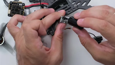 Technical Specialist take apart fpv drone to apply polish silicone Stock Footage 244333819
