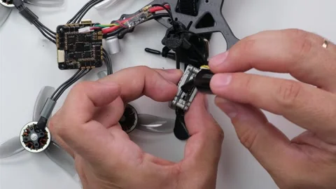 Technical Specialist take apart fpv drone to apply polish silicone Stock Footage 244333985