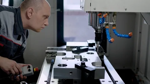Technical specialist working with a metal part on special equipment, industrial Stock Footage 94997690