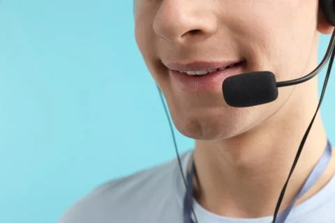 Technical support call center. Smiling operator on light blue background, c.. Stock Photos