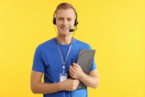 Technical support call center. Smiling operator with clipboard on yellow ba.. Stock Photos